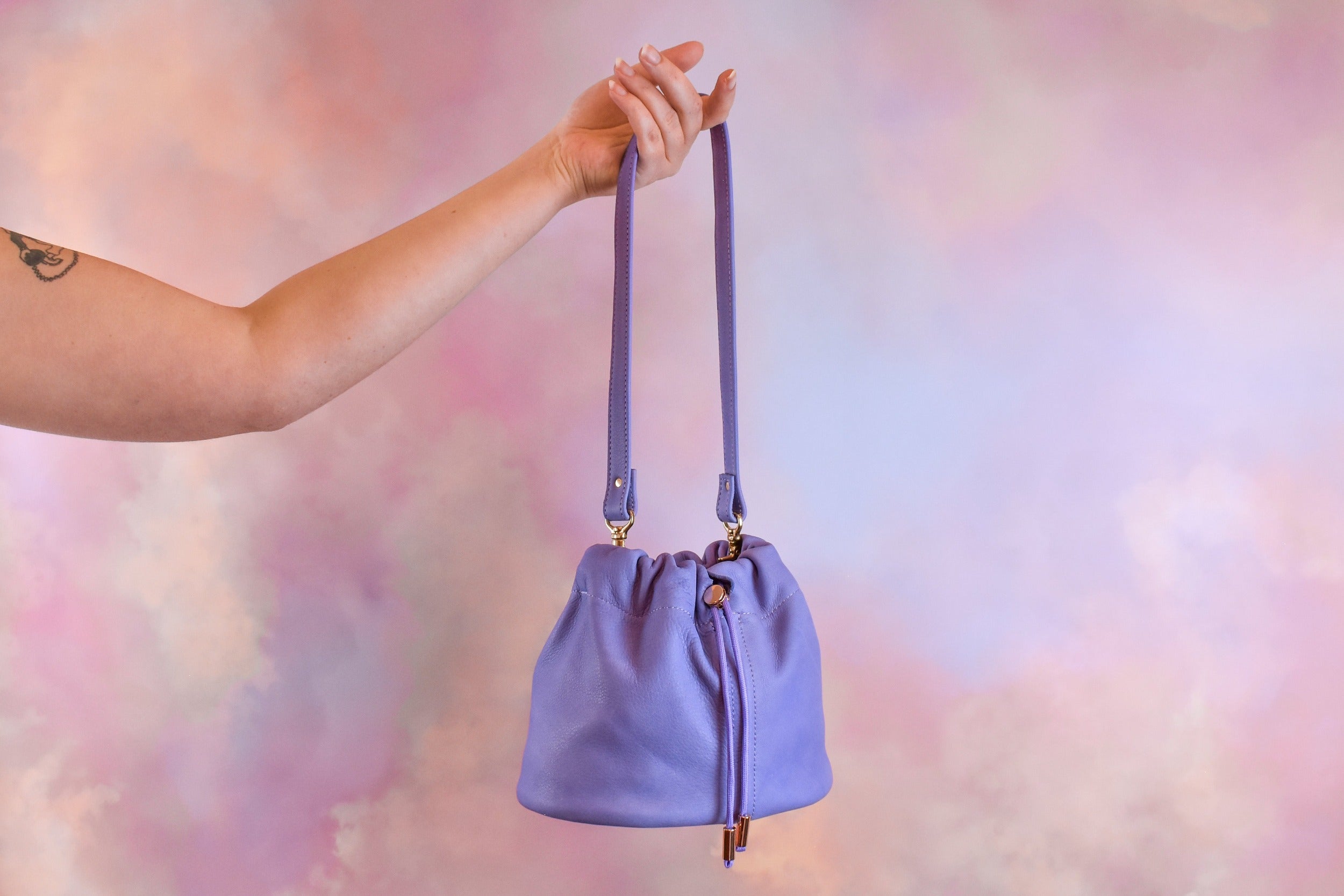 light purple nubuck leather shoulder bag hanging from hand