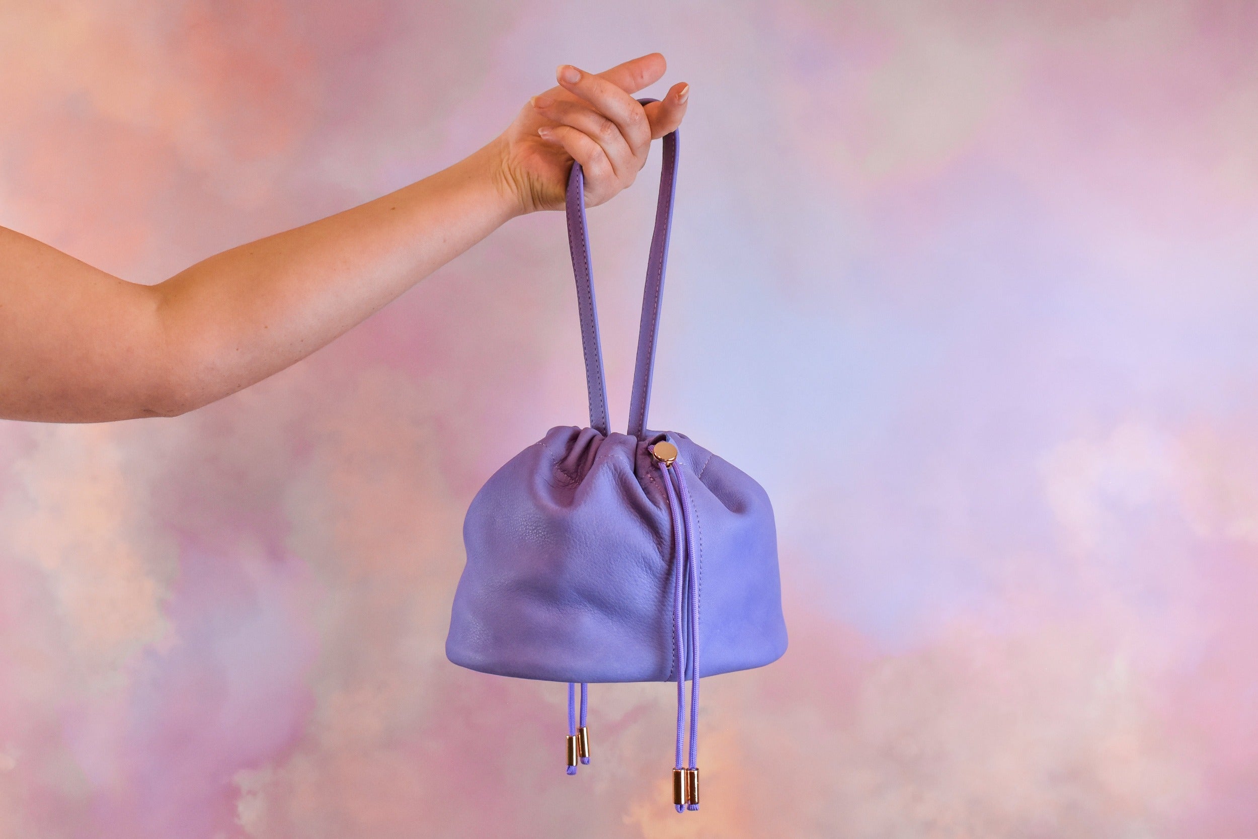 medium sized slouchy muted leather purple drawstring handbag