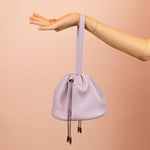 purple leather slouchy handbag with adjustable matching straps and drawstring closure