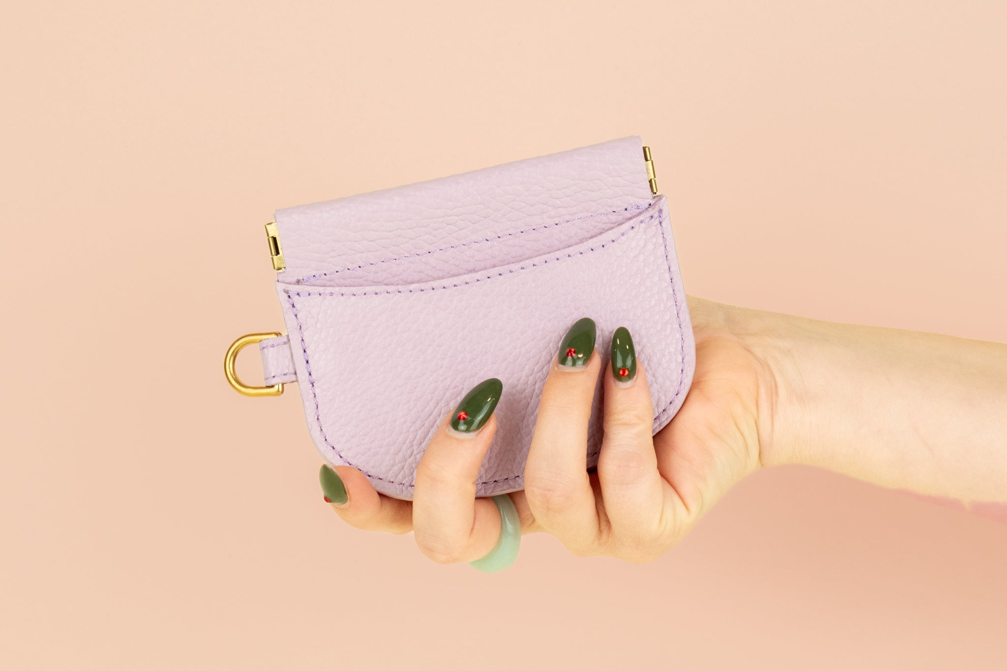 model holding hand stitched pale purple pebbled leather slim cardholder