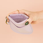 model holding open wallet to show interior pocket and strong stitching
