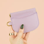 manicured hand holding up handmade cute card holder in lilac leather 