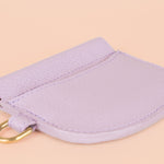 modern leather card holder lying flat to display slim sides featuring gold hardware for attaching keys and snap closure