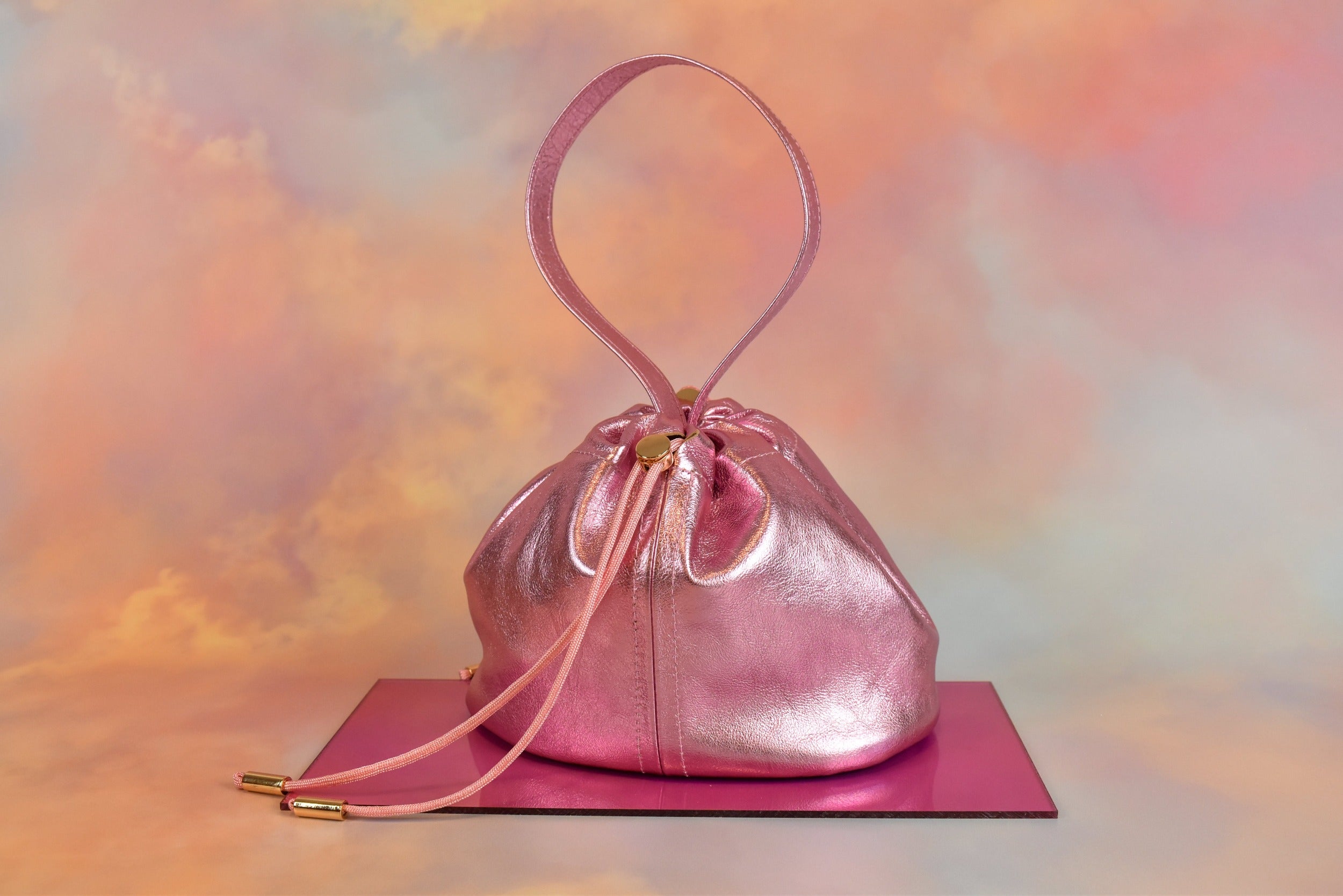 metallic pink leather mini bucket bag drawstring closure unstructured silhouette 