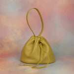 yellow green leather bag unstructured silhouette with drawstring closure