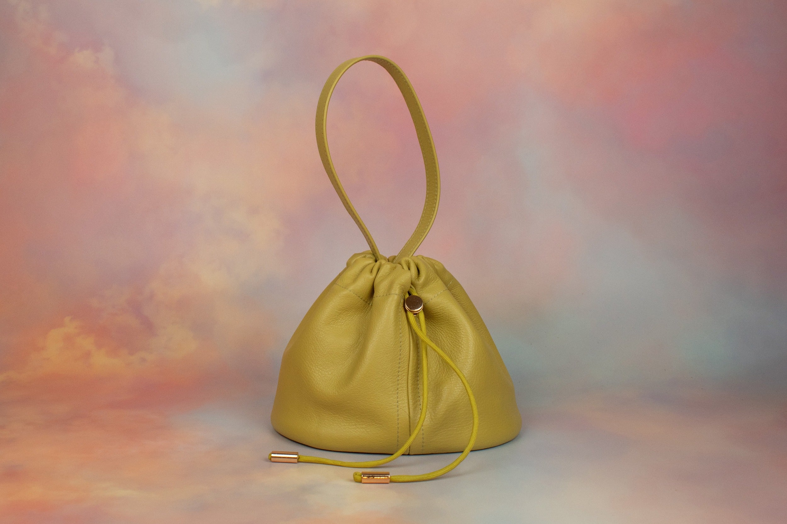 yellow green leather bag unstructured silhouette with drawstring closure