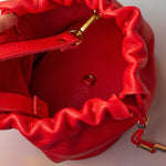 interior of cherry red leather medium sized bucket bag adjustable strap gold hardware
