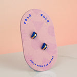 pink card displaying blue sapphire handmade gold hoop stud earrings