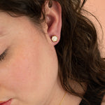 side profile of model wearing gold hexagon earring with polka dot pattern