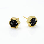 geometric gold plated hexagon everyday earrings in matte black clay with chips of white and granite clay 