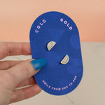 hand holding blue card displaying polymer clay hand marbled crystal quartz white geometric gold half moon stud earrings