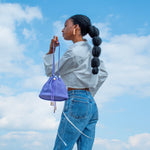 model carrying light purple cute mini leather pouch handbag