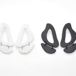 The inferno leather cutout statement earrings in black and white.