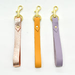 leather loop minimal and modern key chains in marigold lavender and metallic rose leather