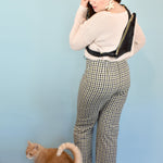 girl with a crossbody style leather bag poses with cat