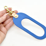 dual colored leather cut out key chain hand strap with gold keyring and spring clasp in bright blue and beige natural authentic leather.