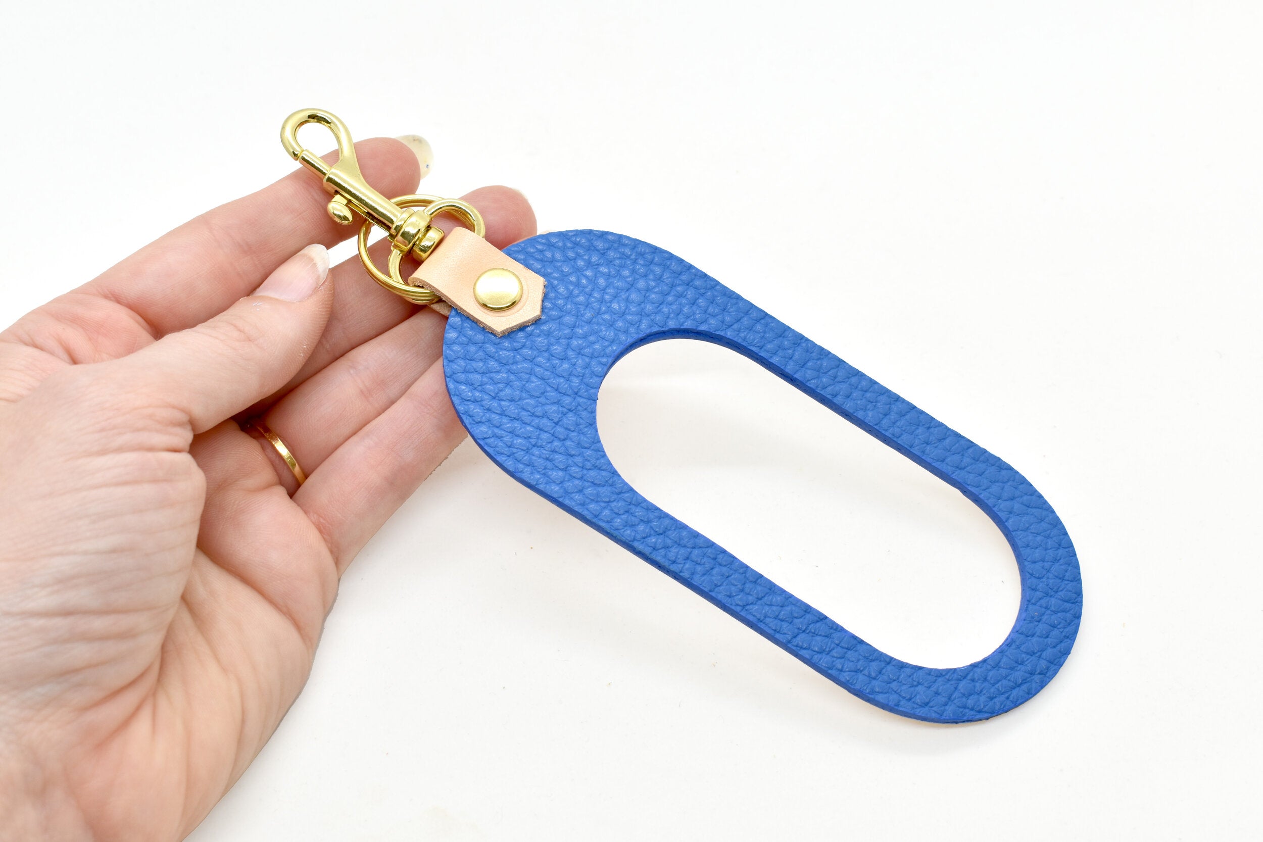dual colored leather cut out key chain hand strap with gold keyring and spring clasp in bright blue and beige natural authentic leather.