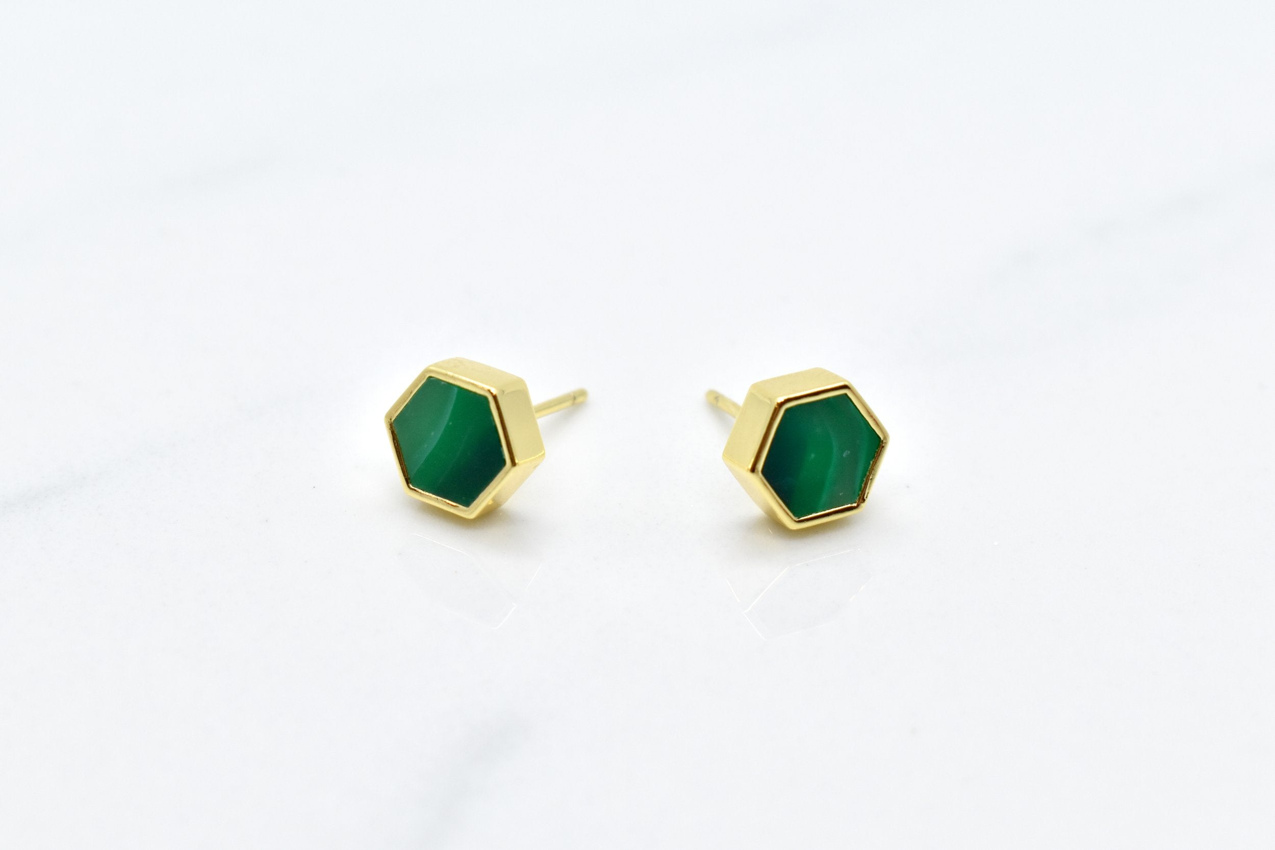 green and gold hexagon stud earring set with swirling emerald texture and 14k gold hexagon shape against a white background