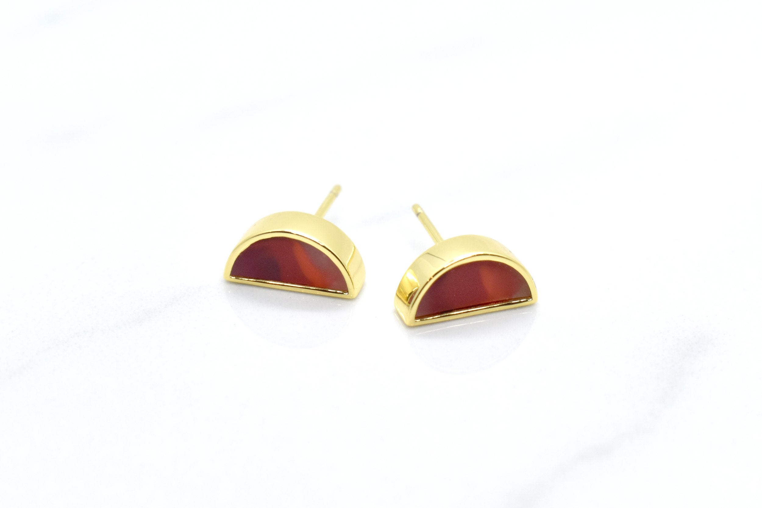 ruby studs with 24k gold plated moon stud earrings on a white background