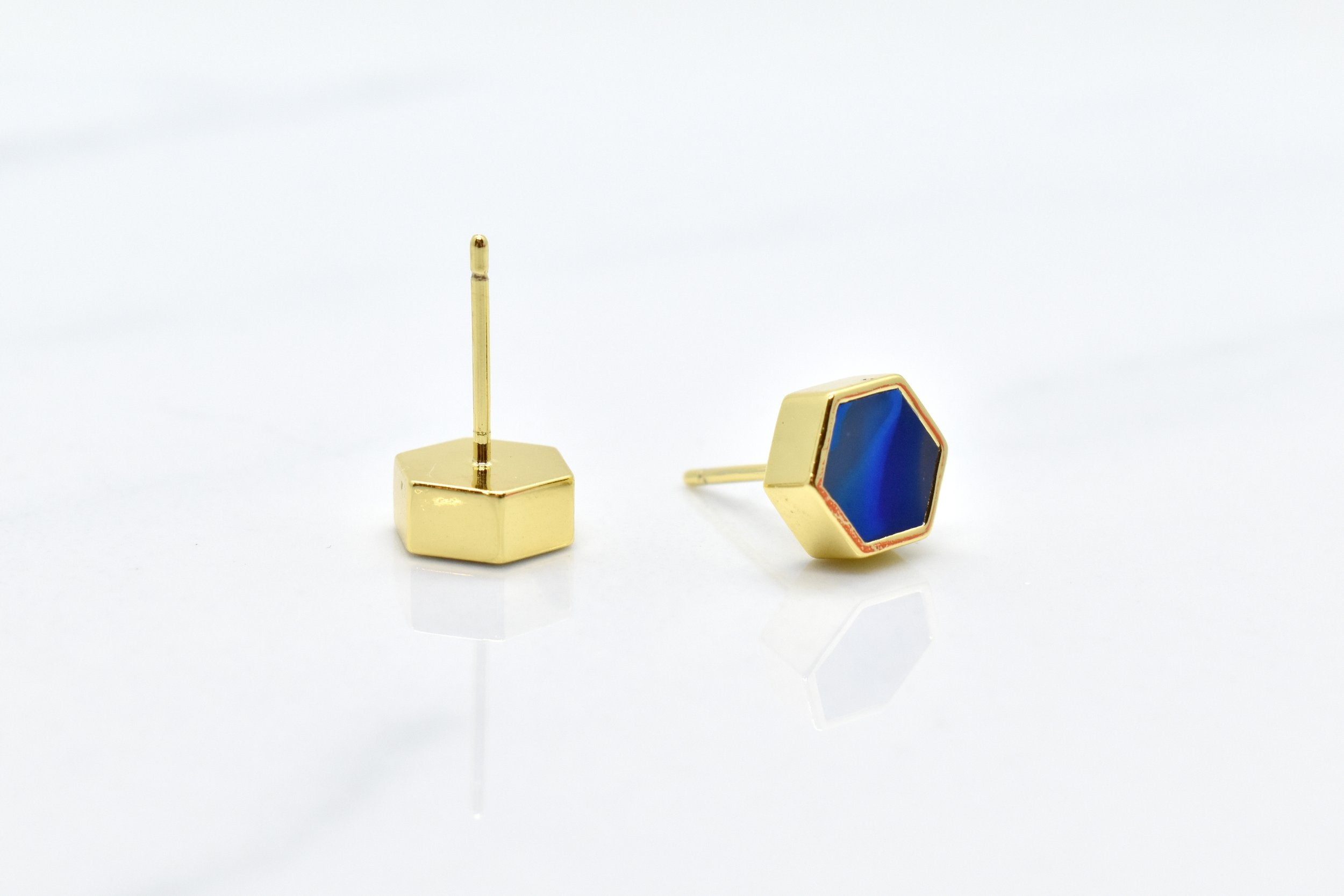 gold hexagon studs with back of stud and surgical steel posts that are hypoallergenic shown against a white background, includes 14k gold earrings with sapphire gem clay