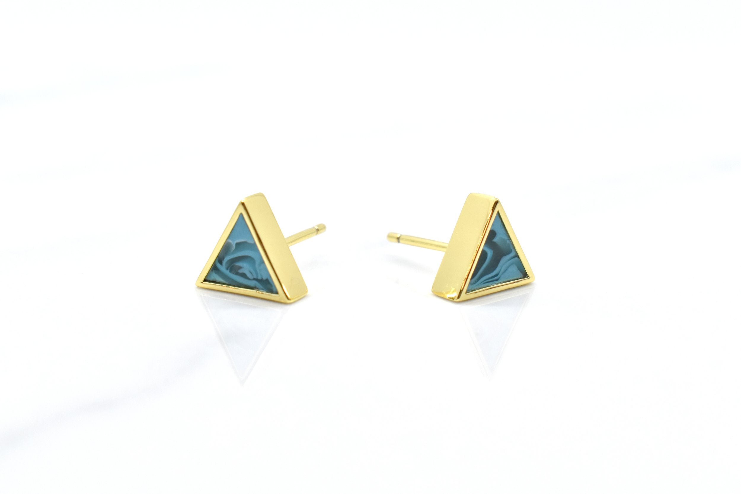 a pair of aquamarine and gold triangle stud earring set shown from the front on a white background