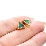 hands holding a pair of geometric triangle stud earrings in emerald green with gemstone texture clay, hand marbled to look like jade, a perfect gift for a september birthday