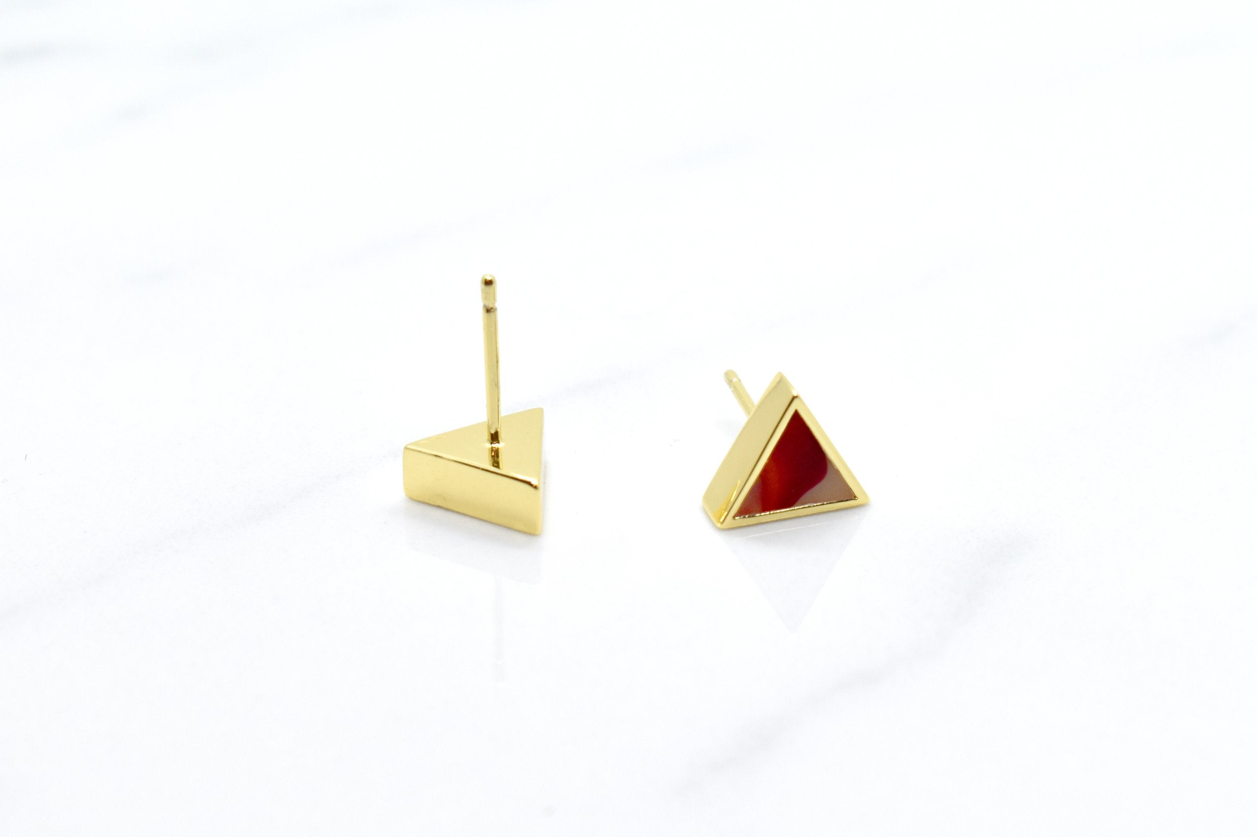 geometric triangle stud earrings in ruby red showing the backside where you can see the surgical steel posts that are hypoallergenic and good for sensitive ears