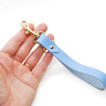 periwinkle blue leather keychain with gold keyring and clasp for keys.