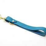 turquoise leather keychain wristlet with gold clasp and key ring.