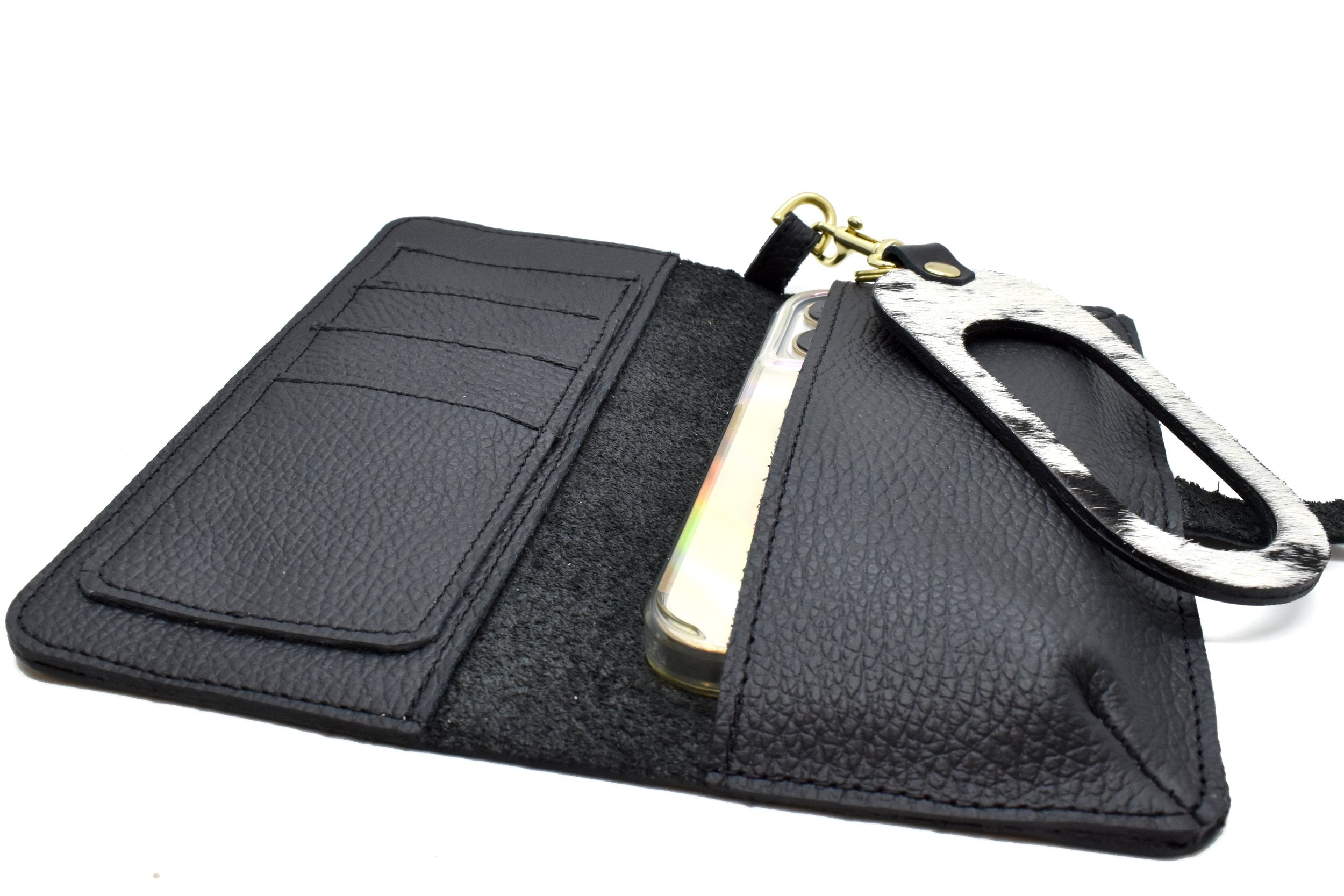 inside of black leather catch all wallet with phone tucked in pocket