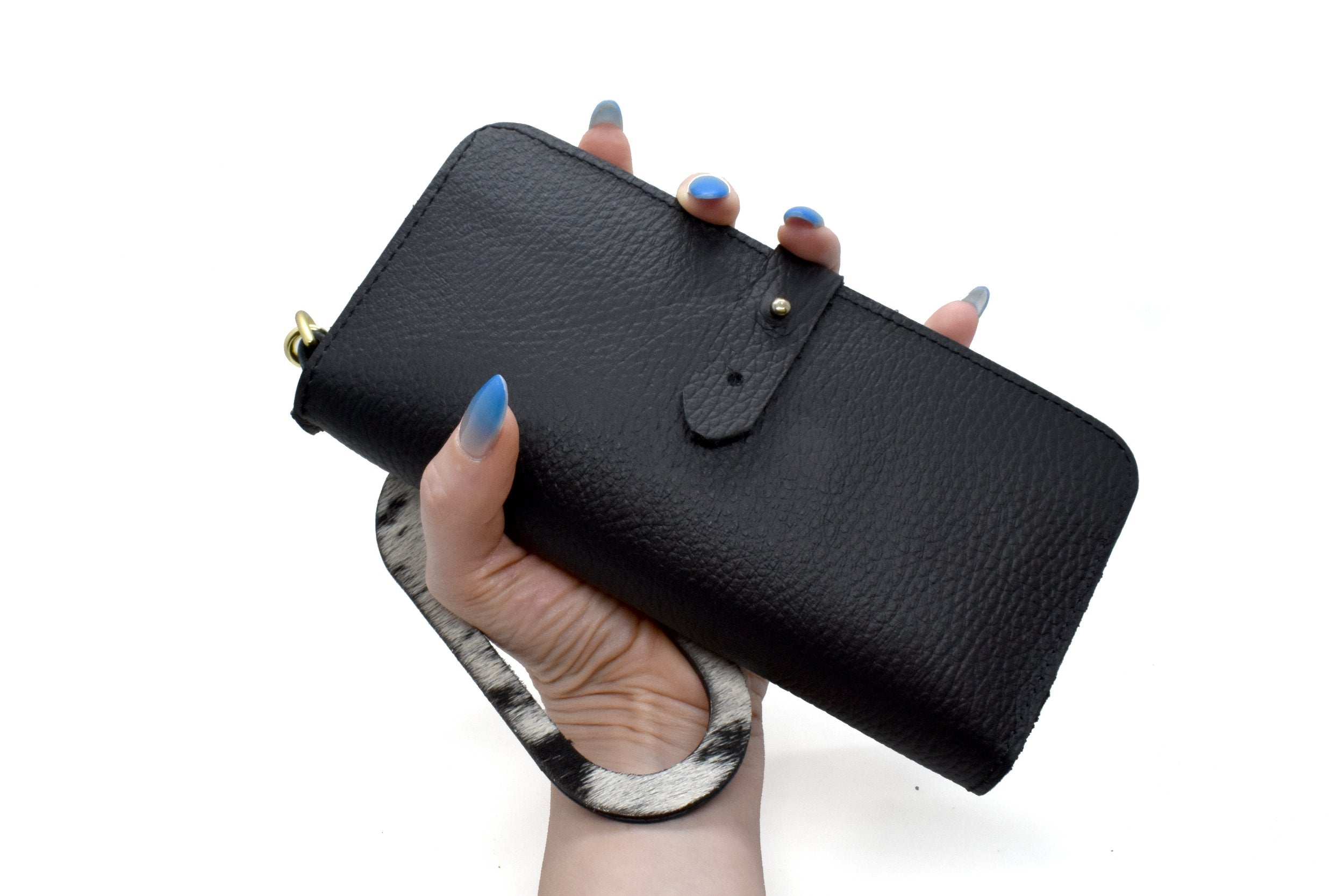 hand holding up pebbled black wallet with western cutout keychain