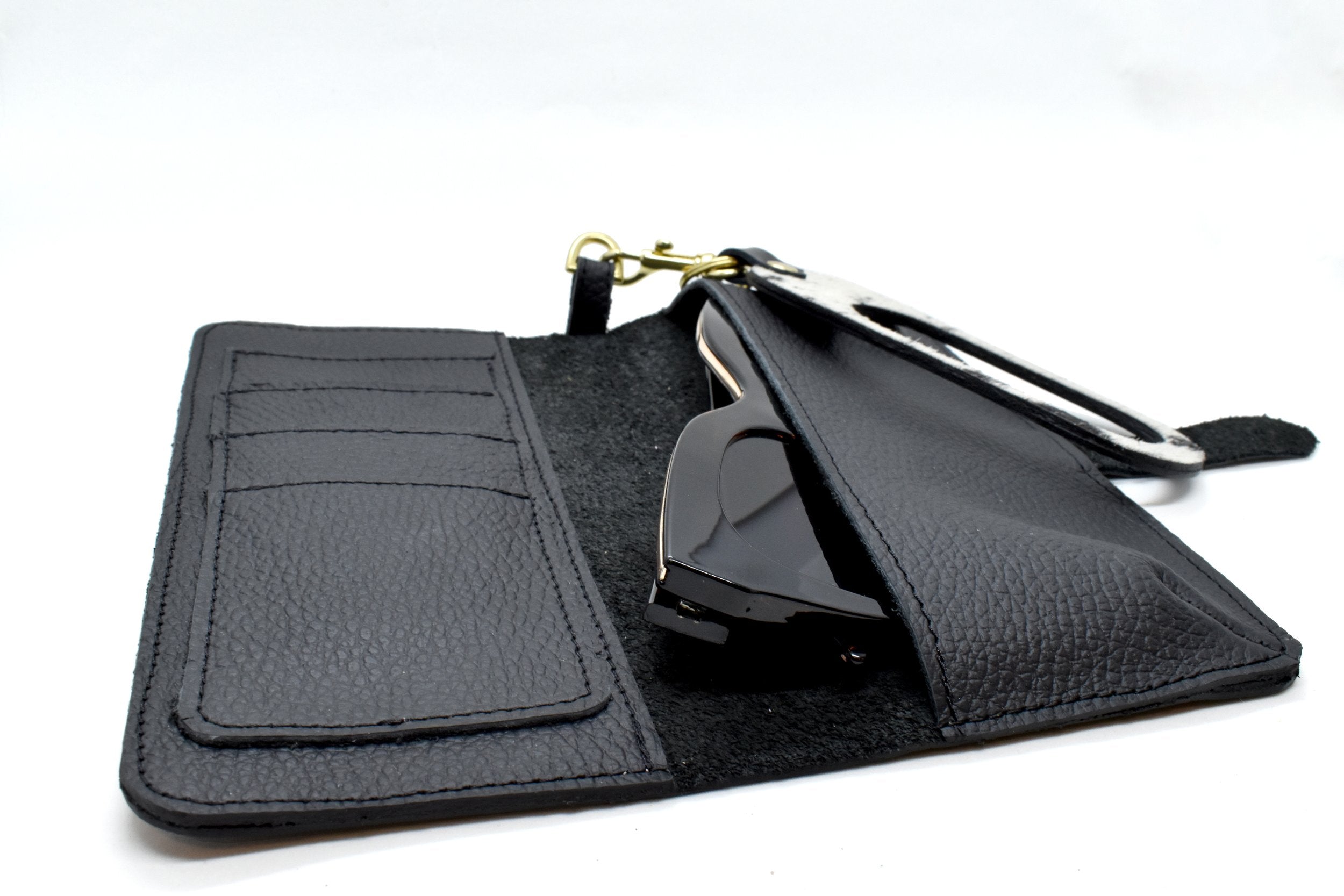 inside of black leather catch all wallet with sunglasses inside pocket