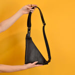 shown from the back, a black bag sling leather purse with a long strap to fit all types, modern crossbody bag in leather