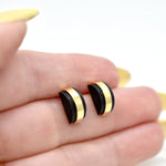 hand holding modern architectural small stud earring set jewelry black clay gemstone