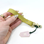 a handmade leather key chain wristlet in lime green with leather wrist strap and gold keyring