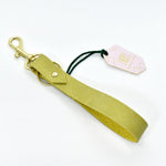 a chartreuse leather wristlet loop keychain with gold polished brass key ring and spring clasp