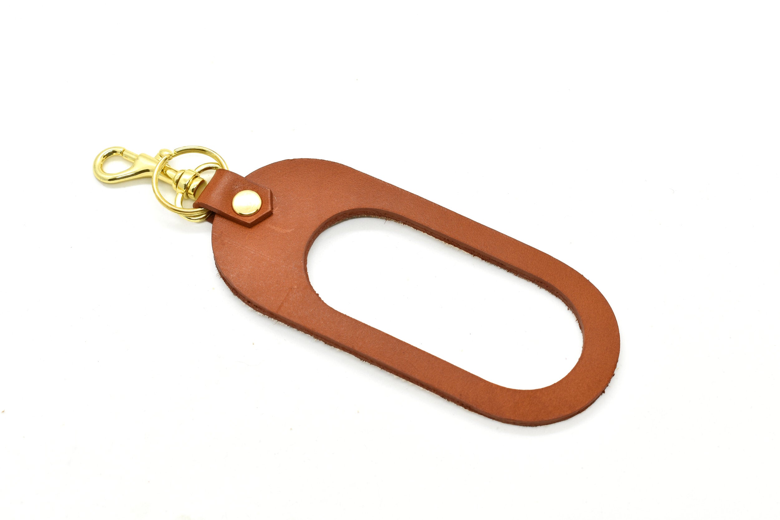 chestnut saddle leather side of the keyhole cutout leather keychain in chestnut brown chestnut speckle hair-on-hide