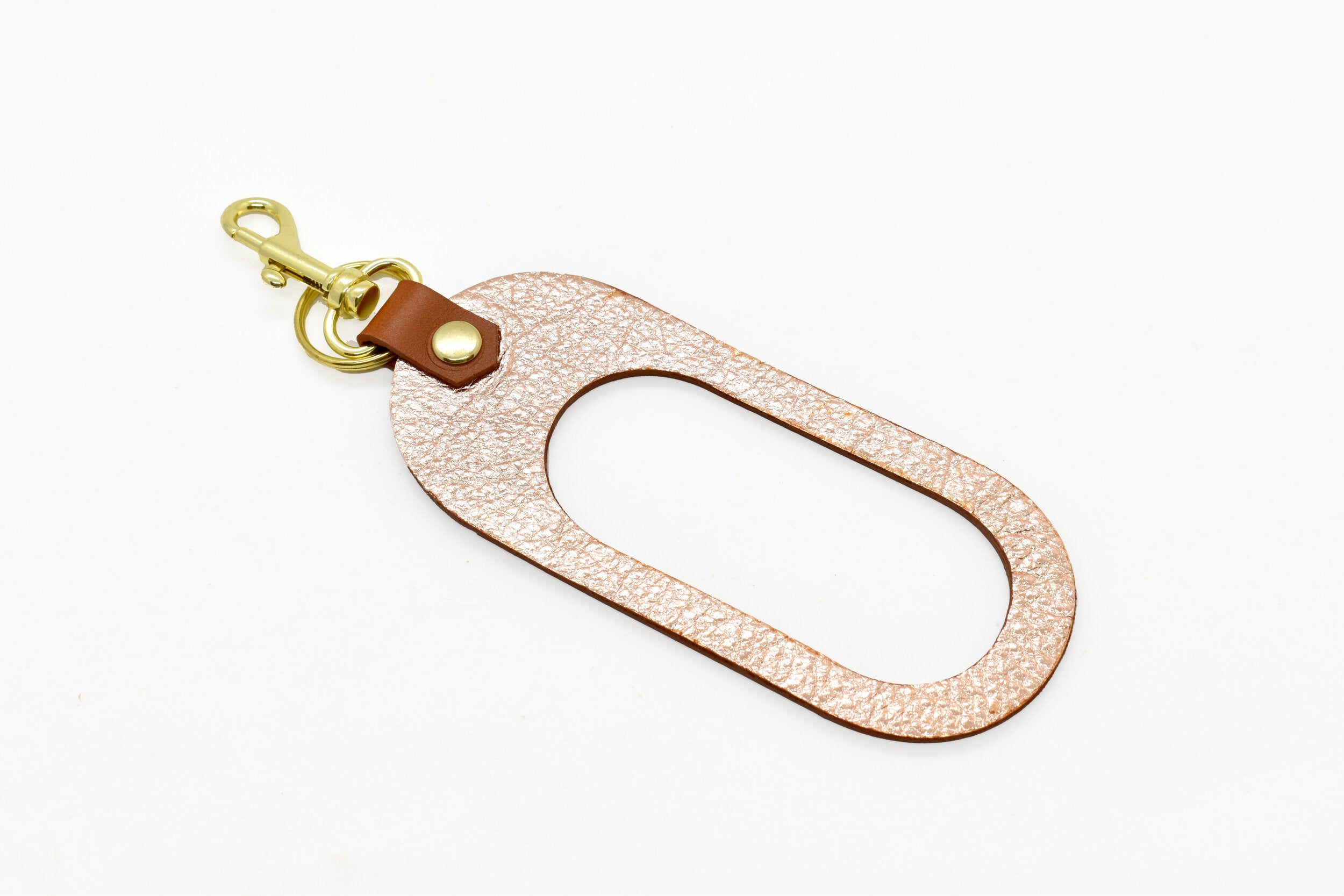 dual colored leather cut out key chain hand strap with gold keyring and spring clasp metallic rose and light brown