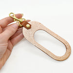 modern leather keychain cutout finished with a gold key ring and clasp