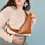 a woman wearing achestnut leather crossbody bag cute maximalist accessory minimal leather bag sling gift for bride bridesmaid gift leather sling with inside pocket