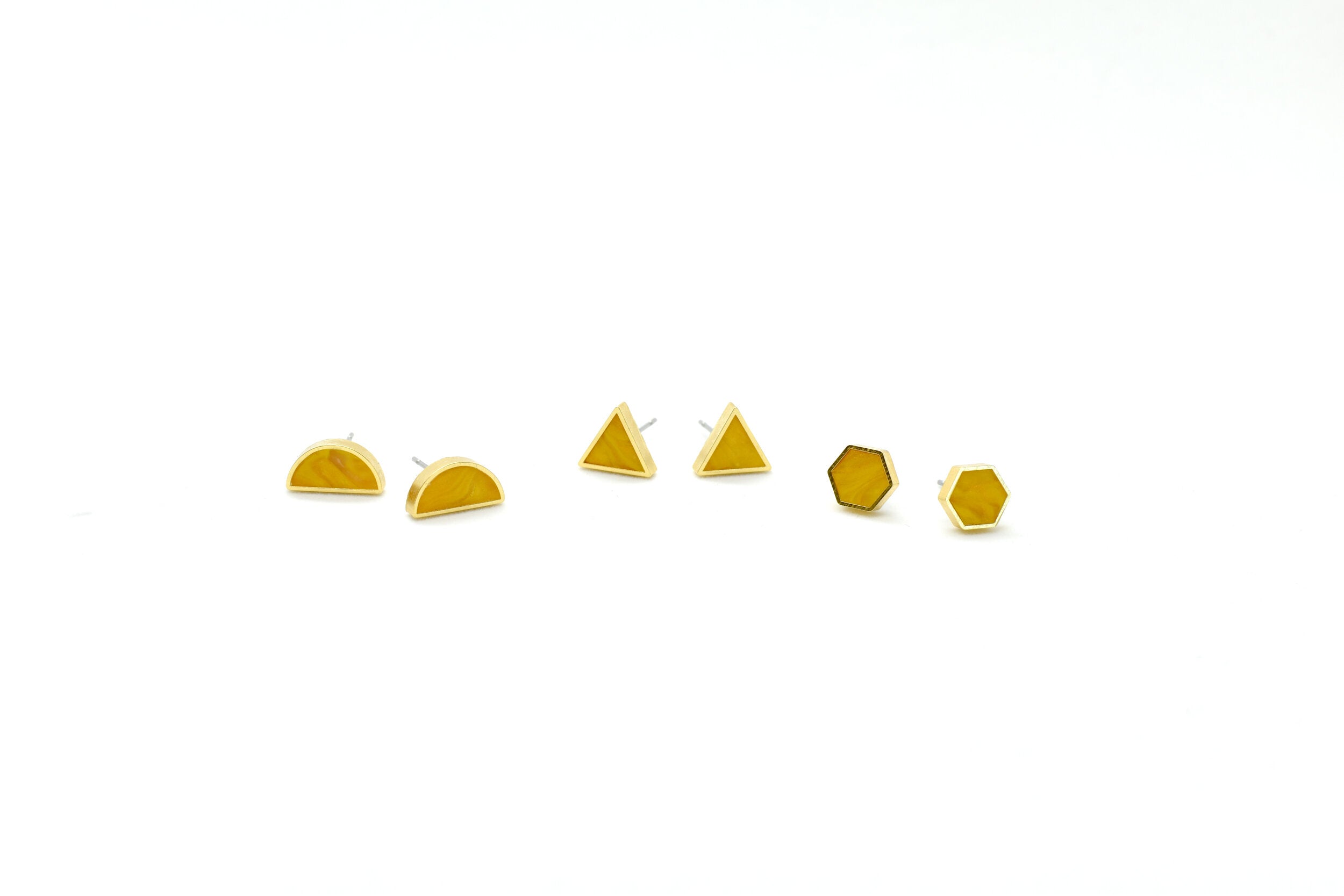 a few pairs of citrine clay stud earrings polymer earrings in geometric shapes hexagon triangle half moon tiny gold studs november birthstone present