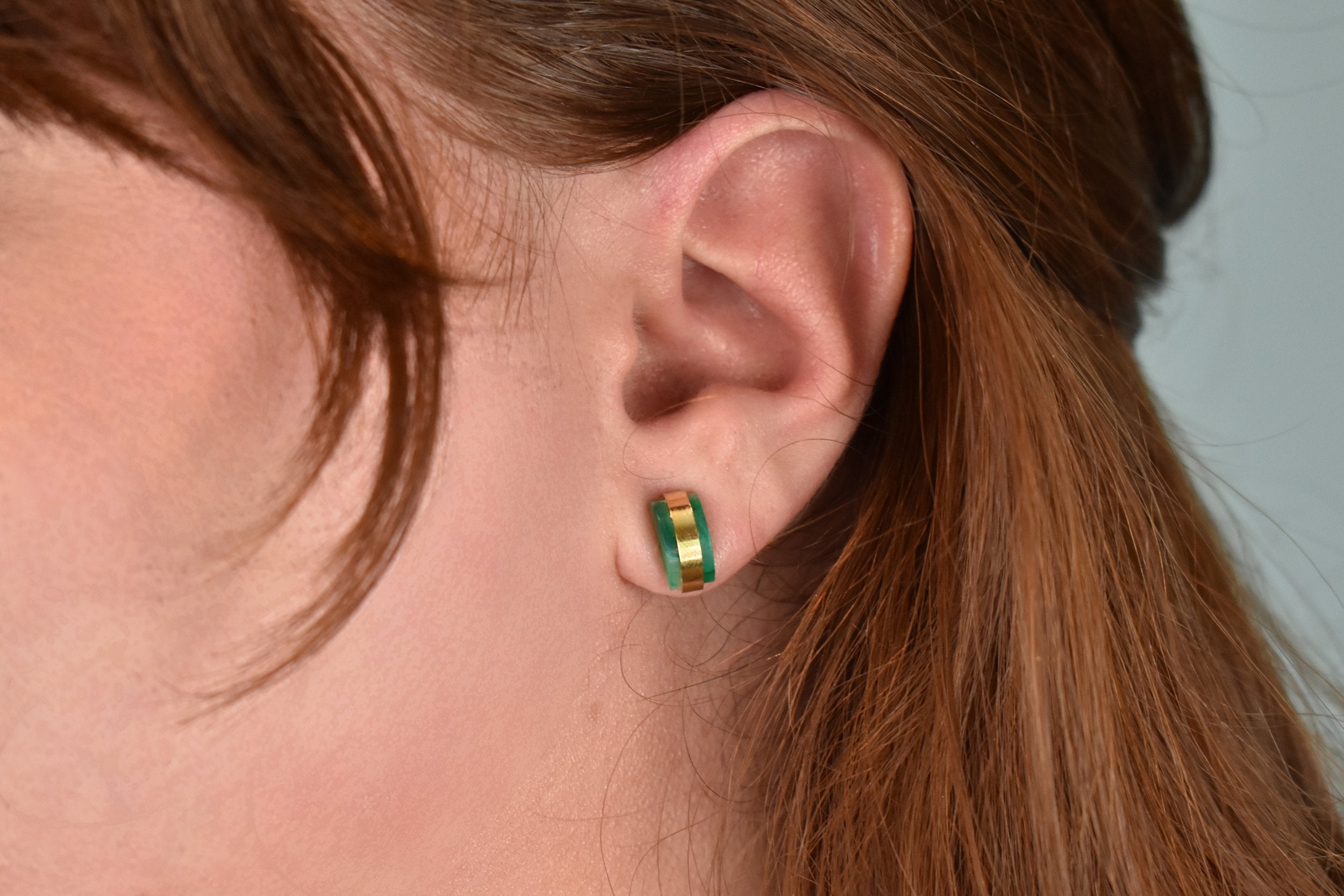 model wearing emerald jade studs gold geometric earring gold studs architectural jewelry simple studs