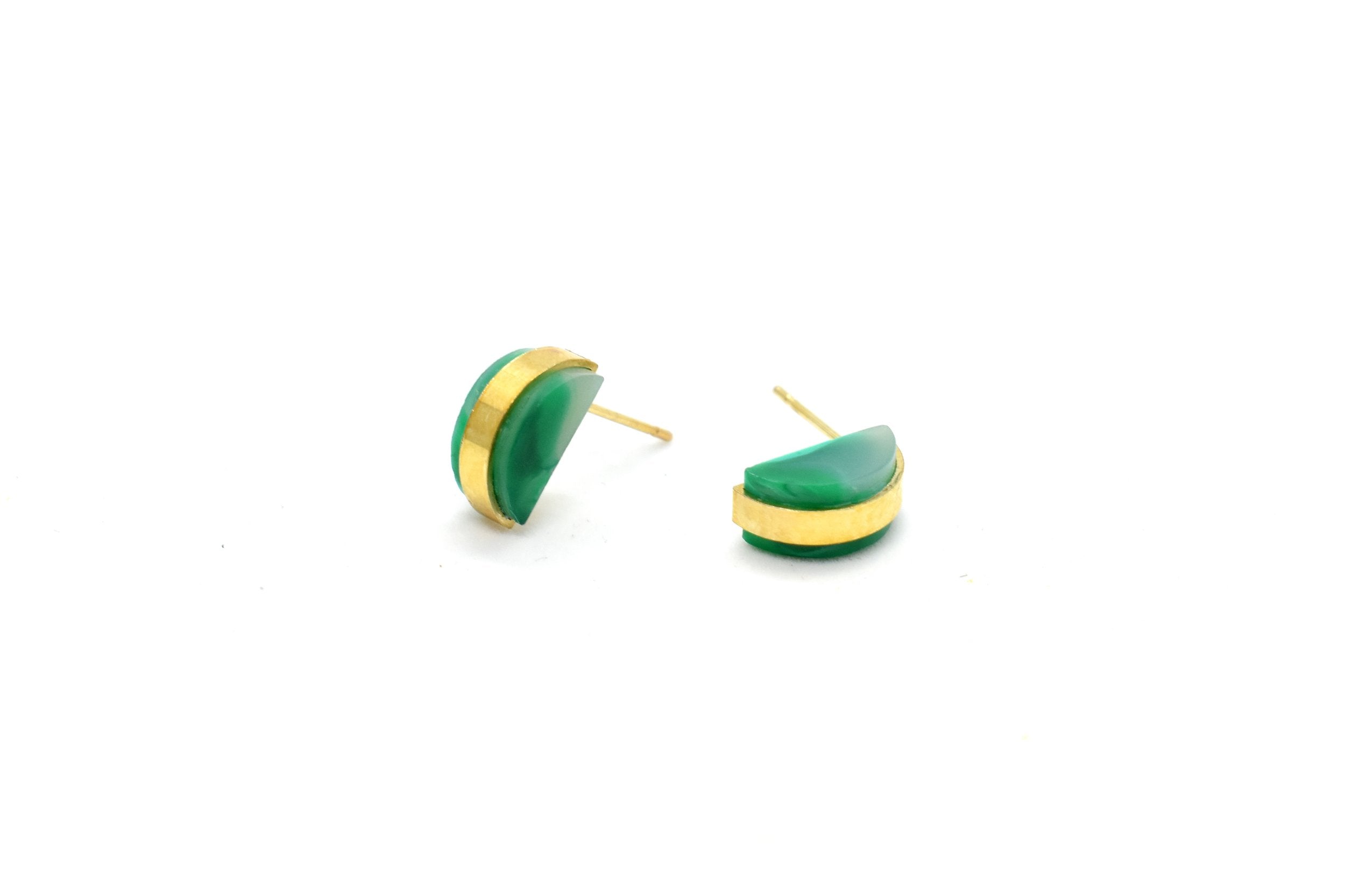 a pair of emerald studs is shown laying down to show off the surgical steel hypoallergenic posts that are great for sensitive ears. The jade studs are great for may birthday gifts