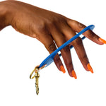 hand holding modern blue keychain wristlet leather keychain wrist strap key fob barbie style