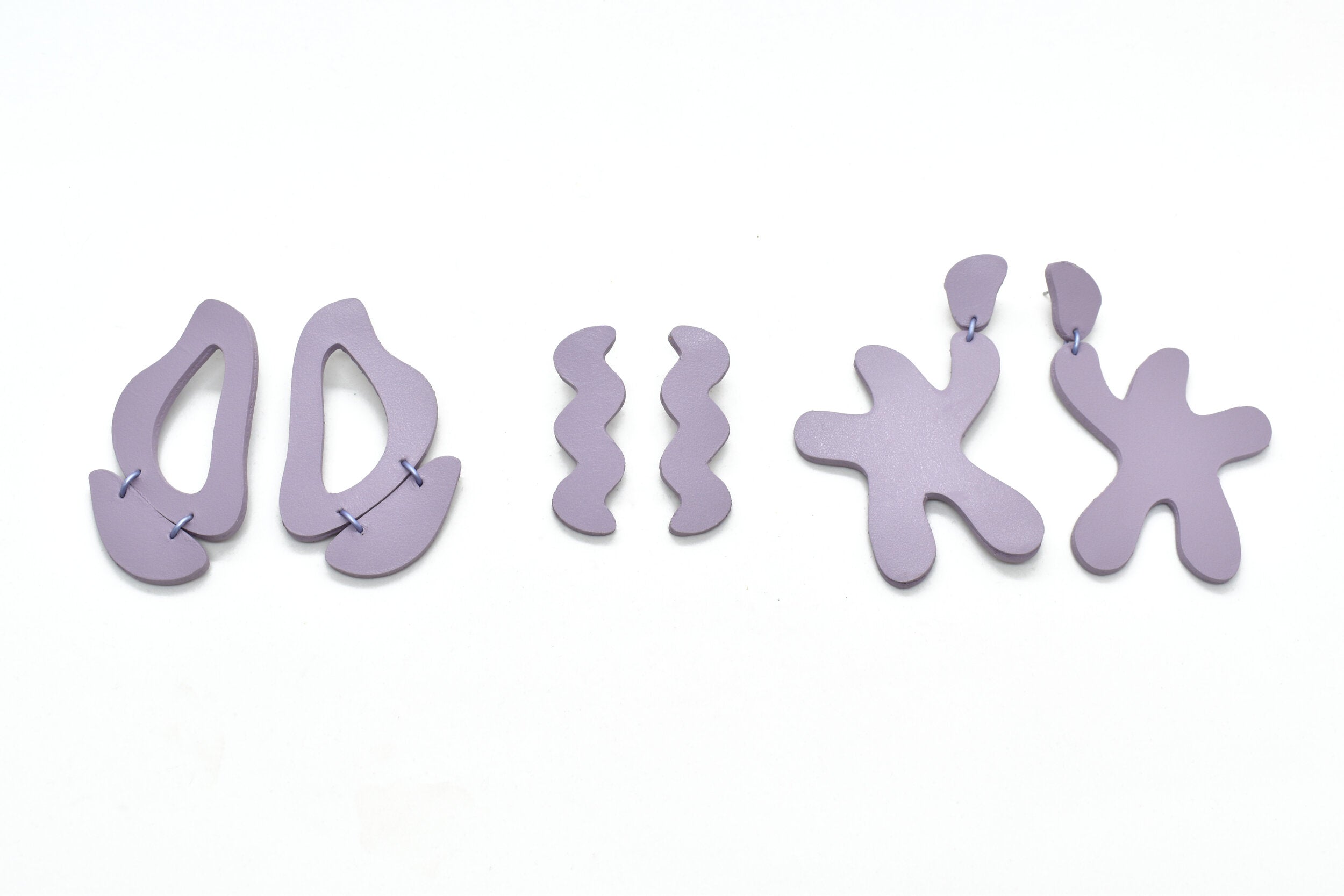three pairs of irregular shape oversized statement earrings in real lavender leather.
