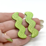 hand holding Metallic Lime Green Zigzag Statement Earrings, Metallic Leather Matisse Earrings