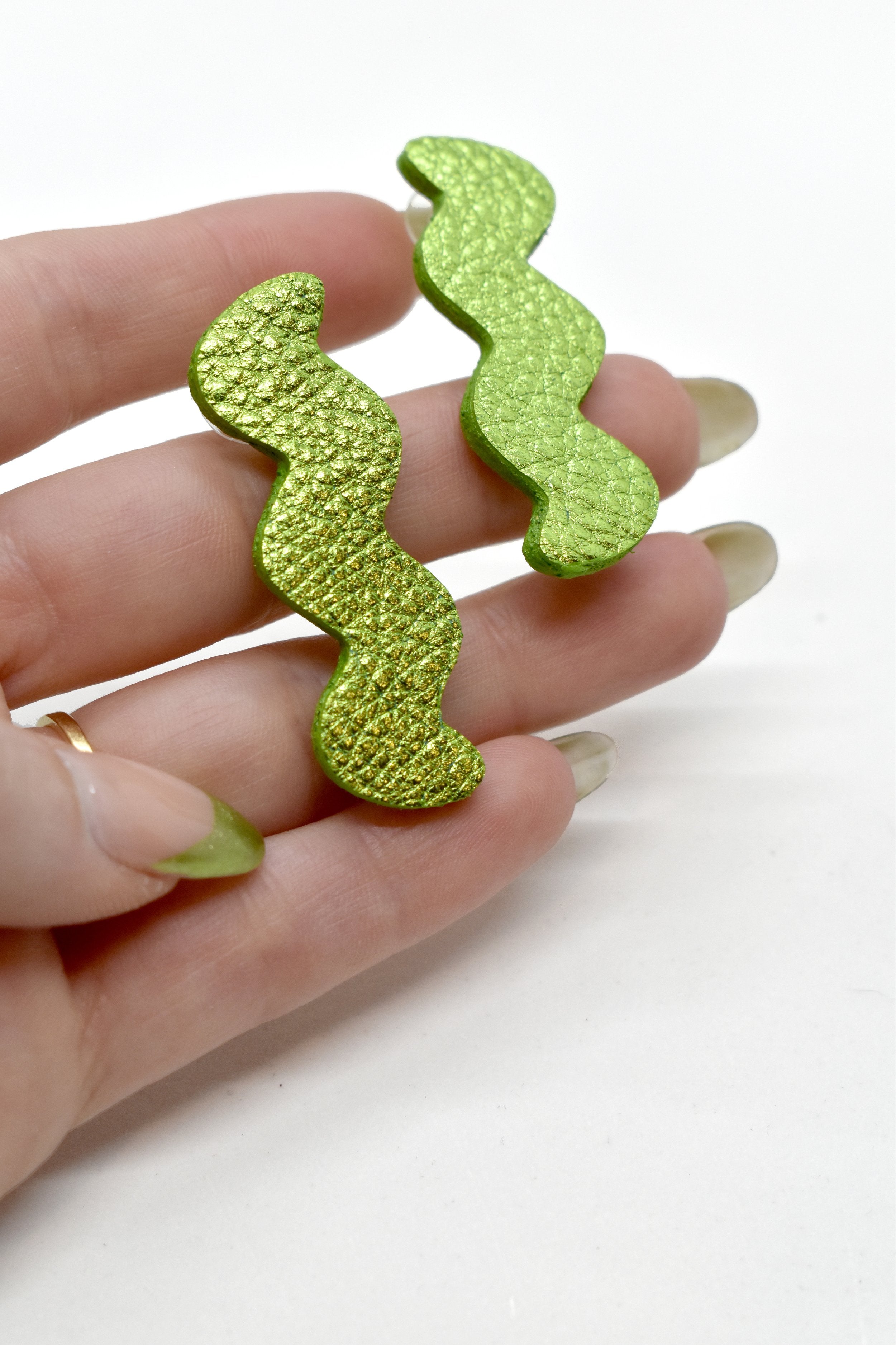Hand holding Metallic Lime Green Zigzag Statement Earrings, Metallic Leather Matisse Earrings
