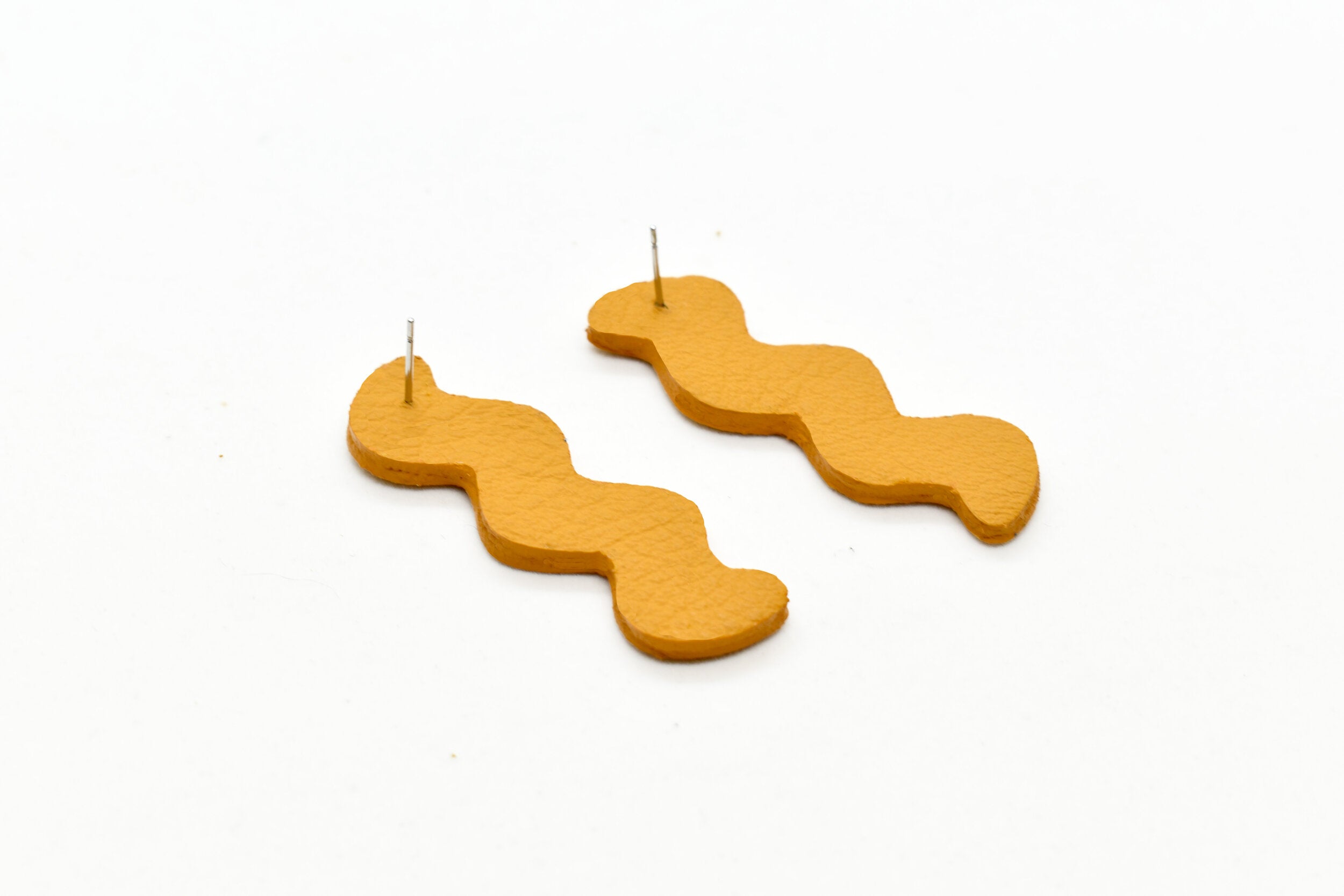 modern wavelength cutout leather earrings with surgical steel ear studs