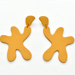 real leather star shaped statement earrings in bold marigold