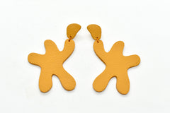 real leather star shaped statement earrings in bold marigold